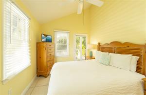 This bedroom features a queen bed and front balcony access.