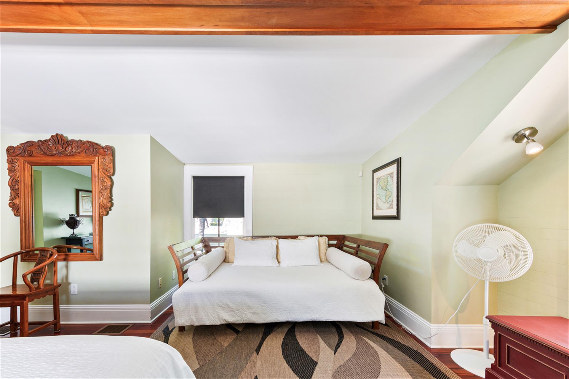 Primary bedroom includes day bed for napping