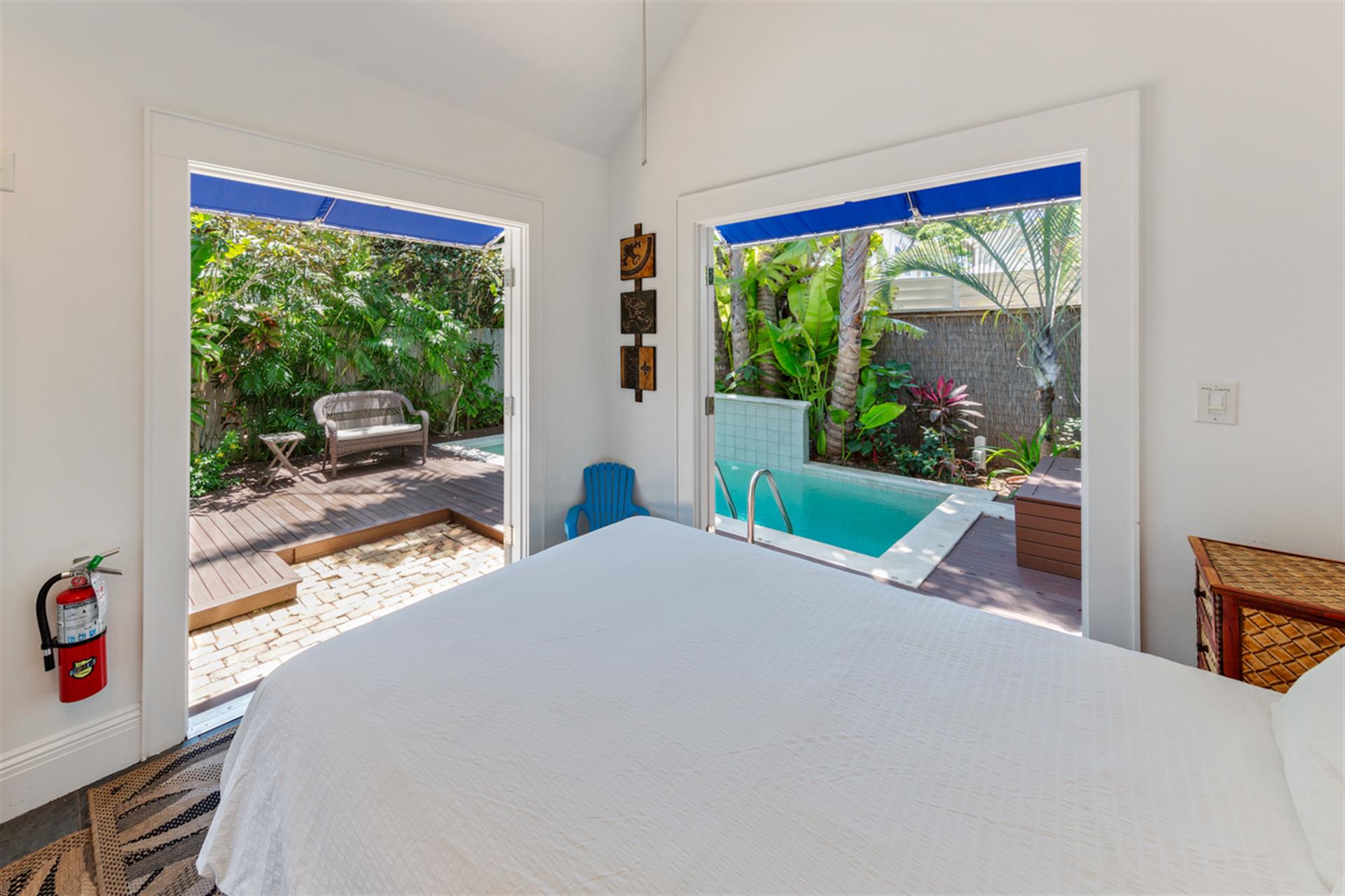 Separate pool house with queen bed and double French doors.