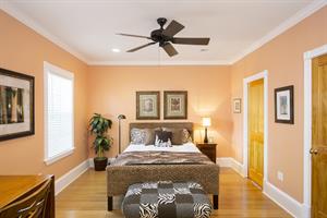 Stylishly furnished queen bedroom with ensuite bath.