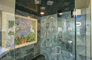 Enjoy multiple shower heads and custom tile.