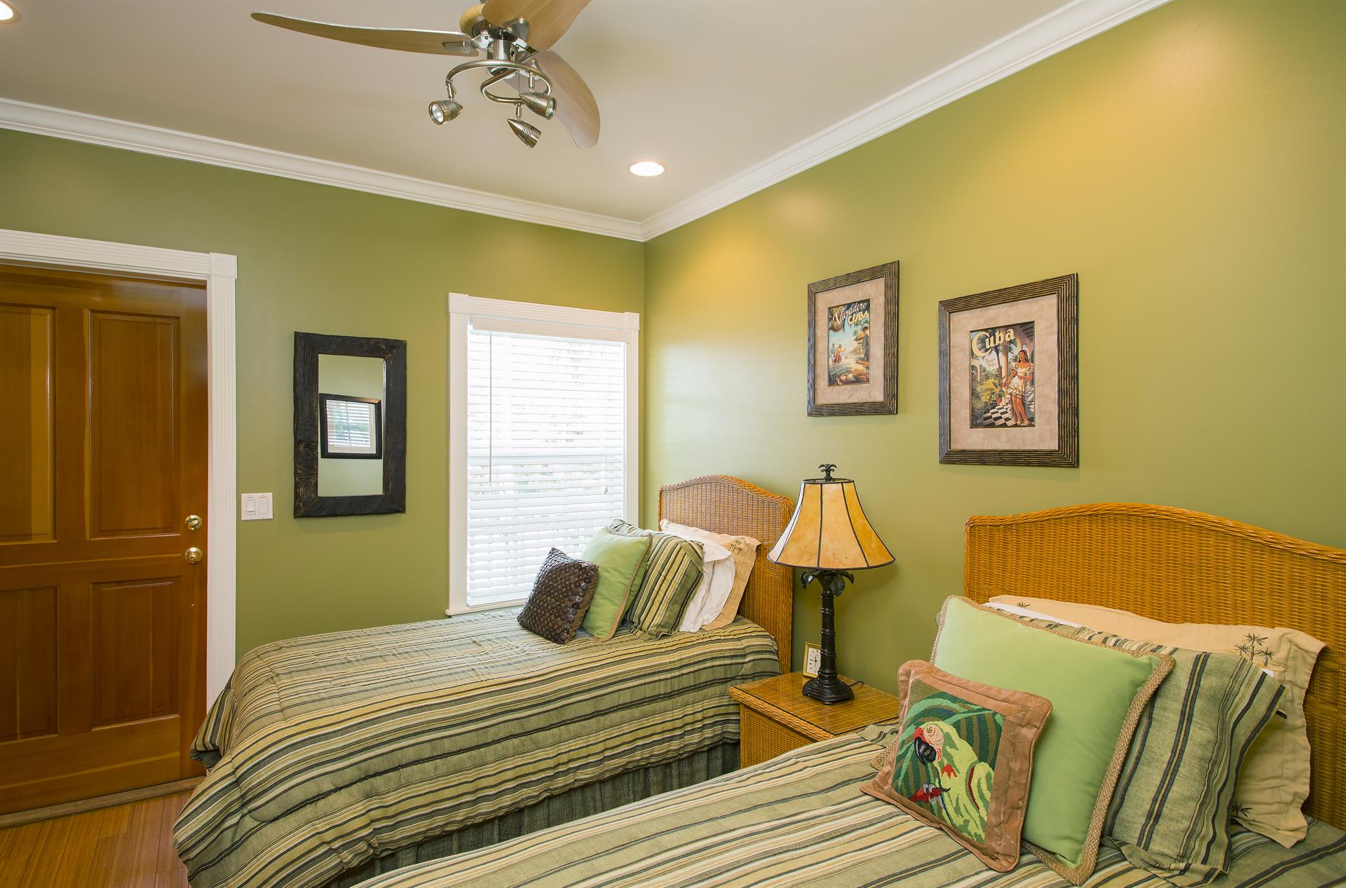 Cozy twin bedroom with access to second floor porch.