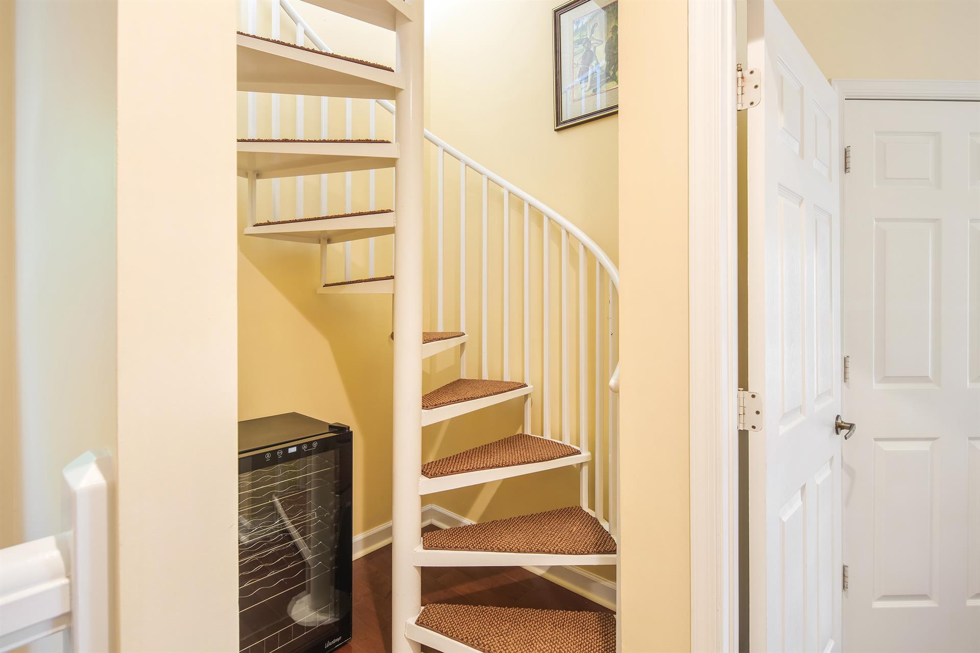 Spiral staircase leading to rooftop deck.