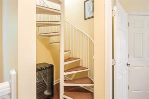 Spiral staircase leading to rooftop deck.