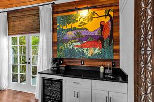 Wet bar with beverage fridge, microwave, sink, and coffee maker