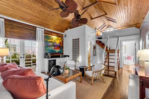 Living room with open staircase to loft
