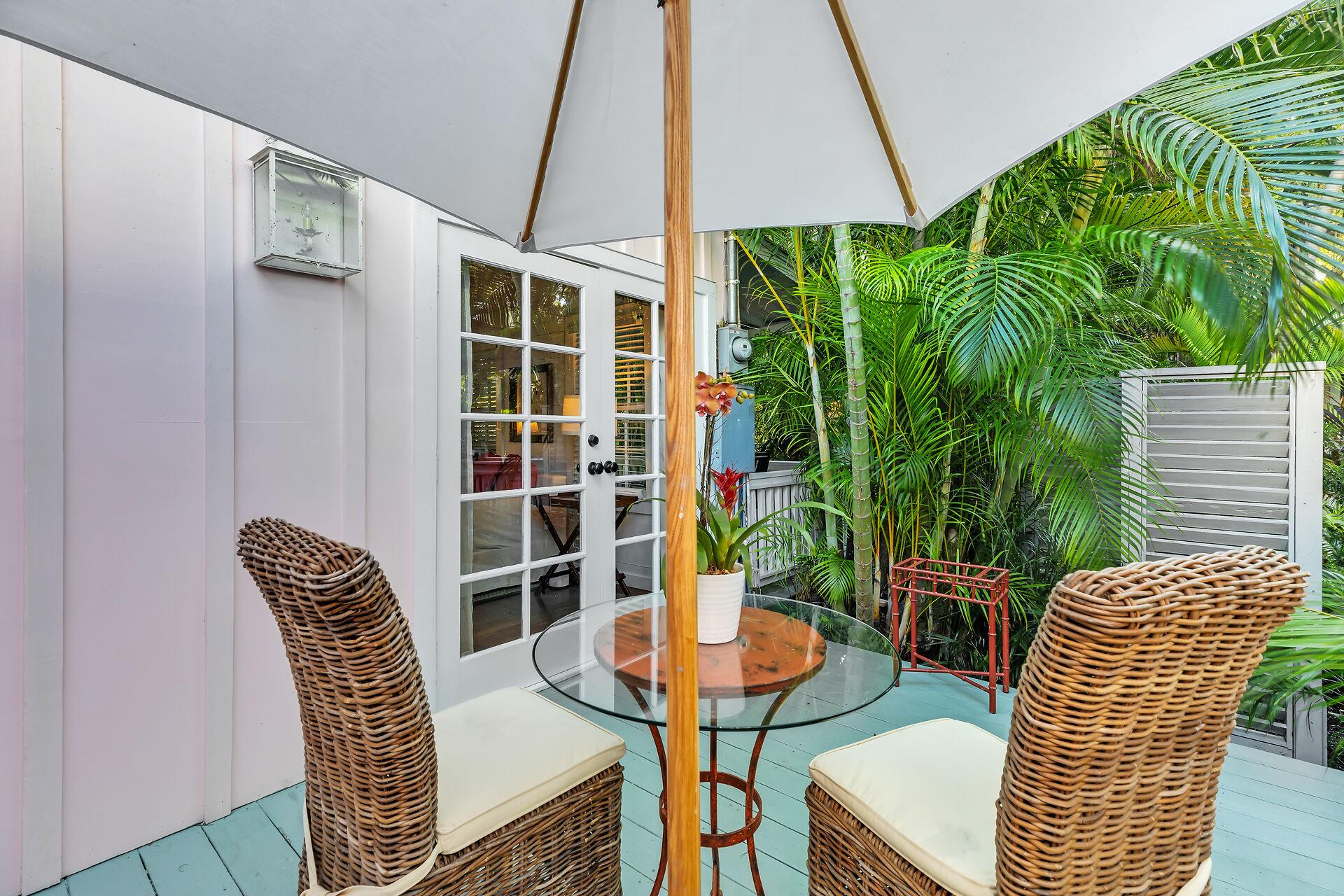 Private deck off living room with quaint furniture