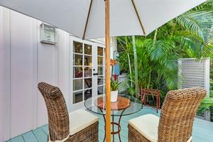 Private deck off living room with quaint furniture