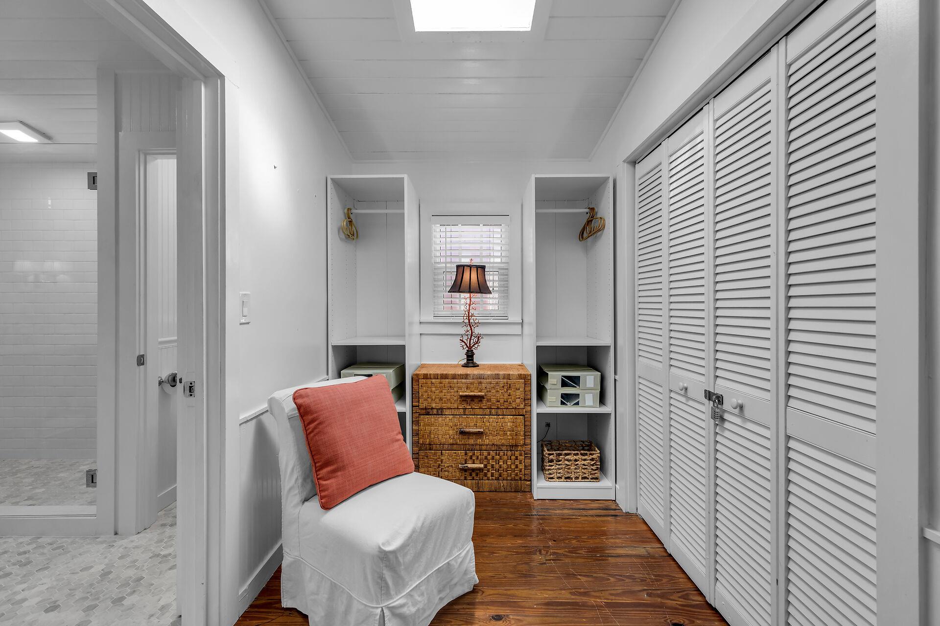 Great primary closet area with slipper chair
