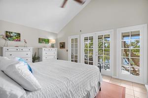 King primary bedroom with ensuite and balcony