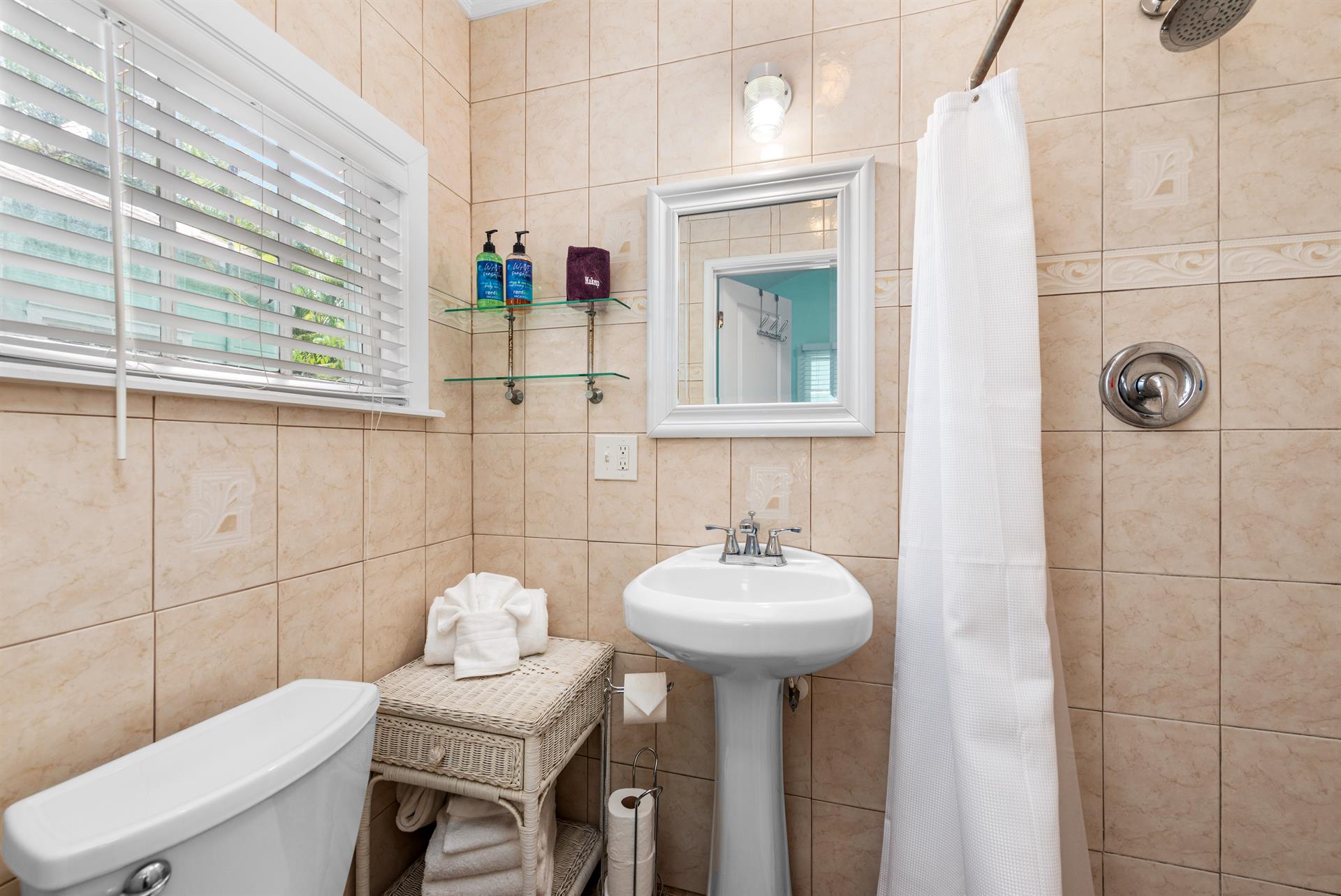 Full bath with walkin shower and pedestal sink