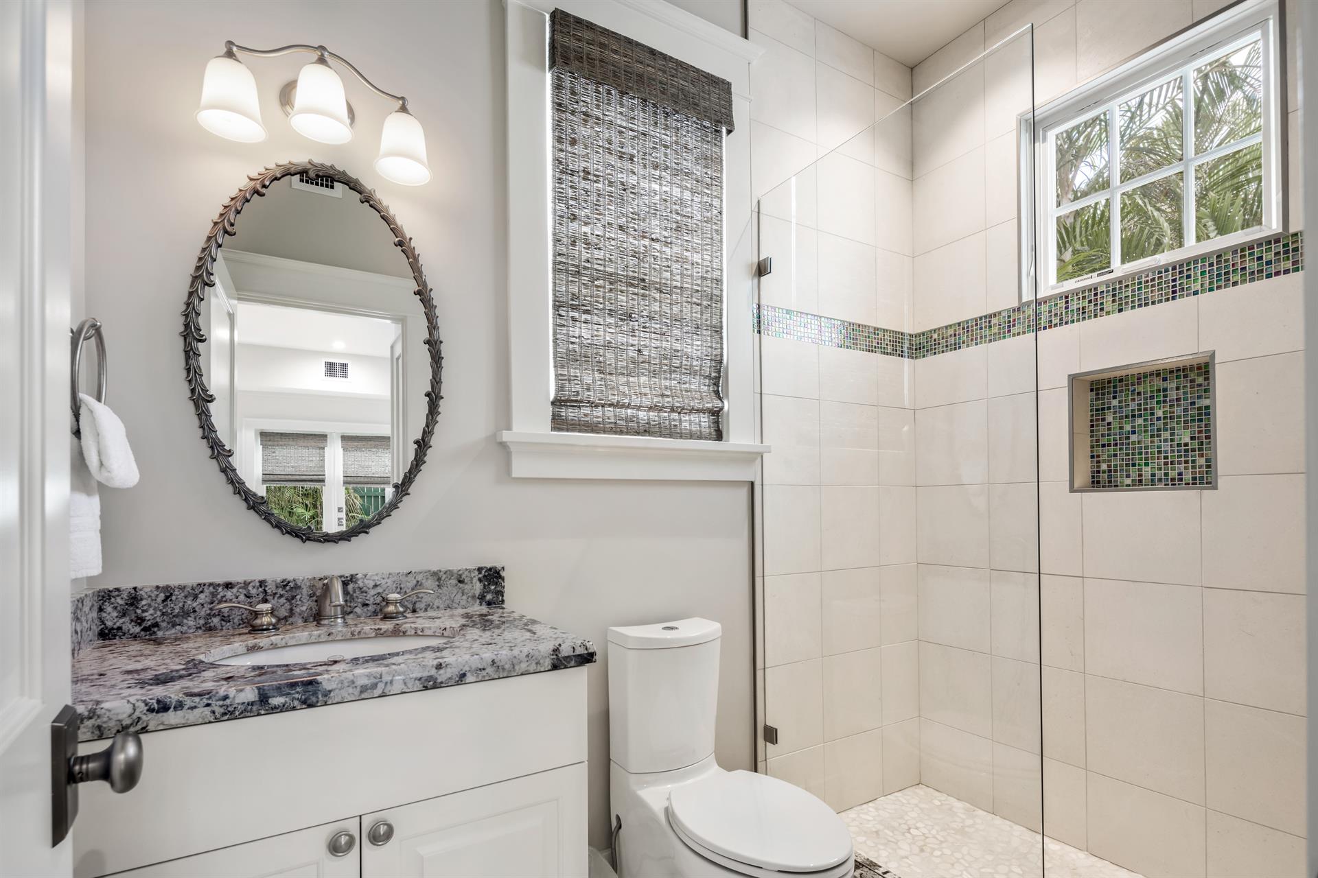 Full bath with glass walkin shower on first floor.