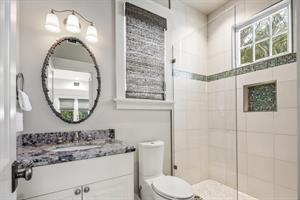 Full bath with glass walkin shower on first floor.