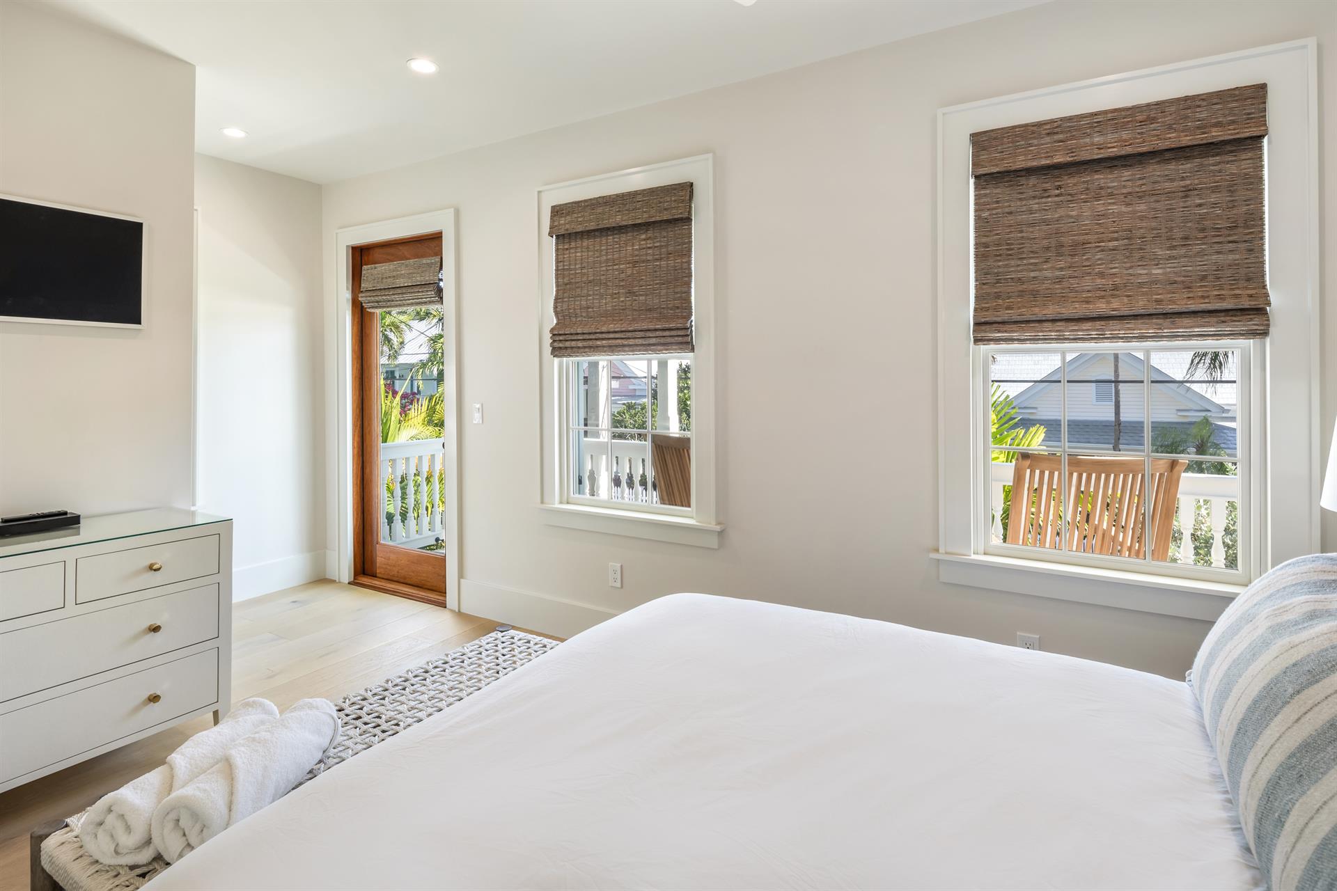 Guest room has access to second floor balcony with seating.