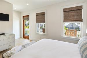 Guest room has access to second floor balcony with seating.