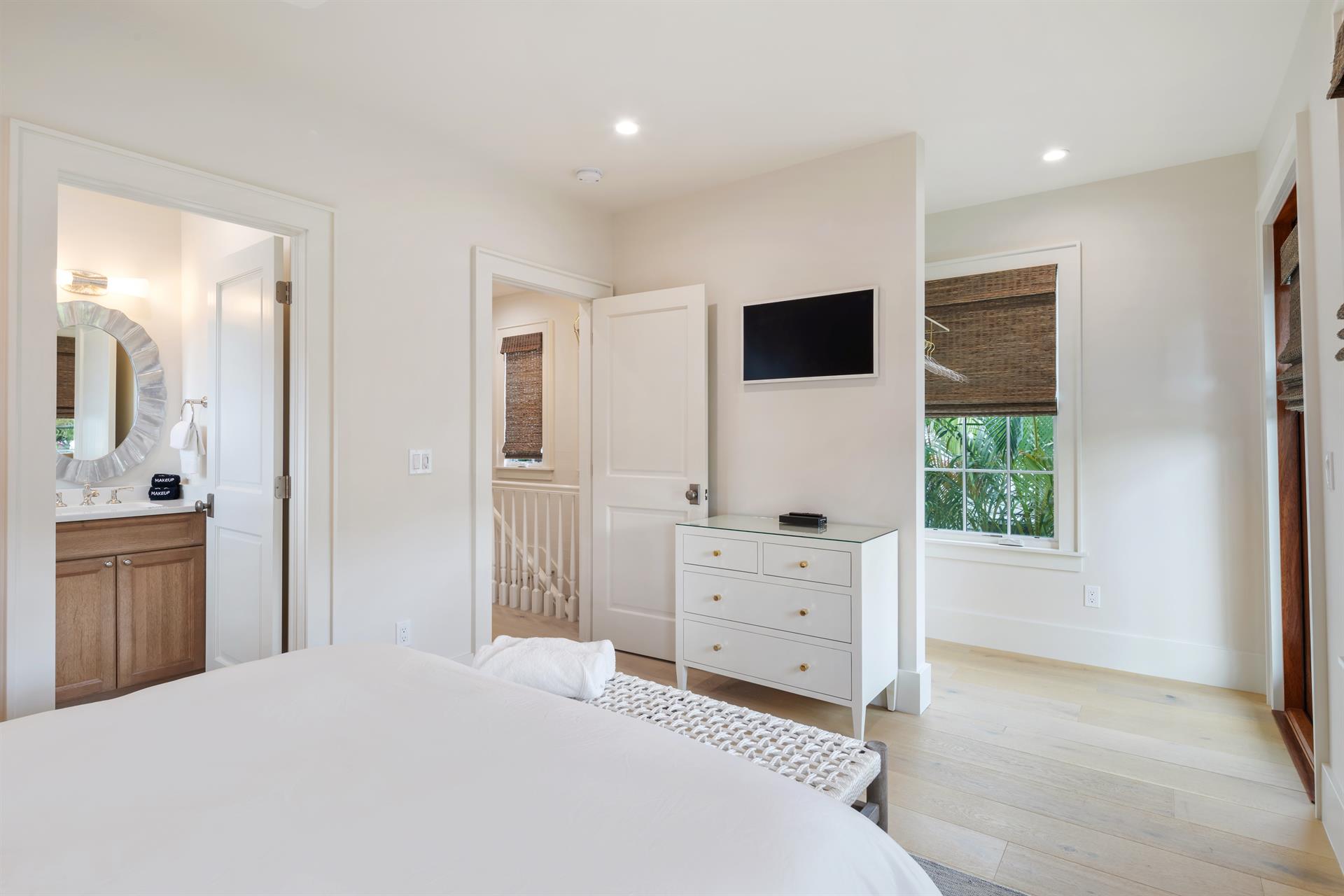 TV, dresser and ensuite in queen guest room.
