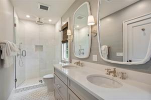 Double sinks and glass walkin shower in primary bath.
