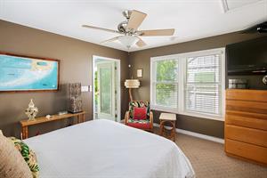 The primary bedroom has access to the pool area.