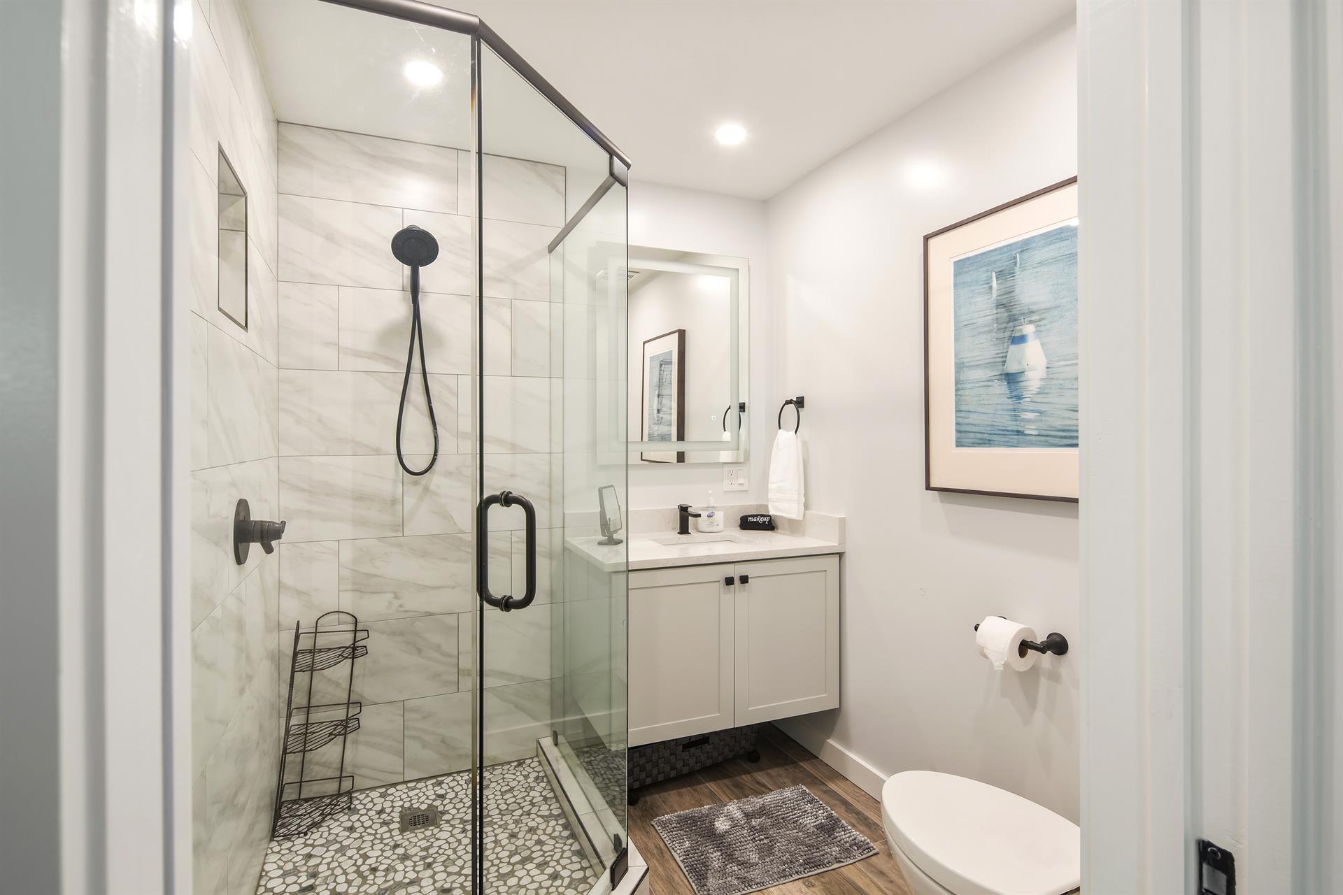 The second bedroom has ensuite bath with glass walkin shower