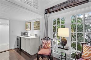 Kitchenette has a sink, beverage fridge, and microwave