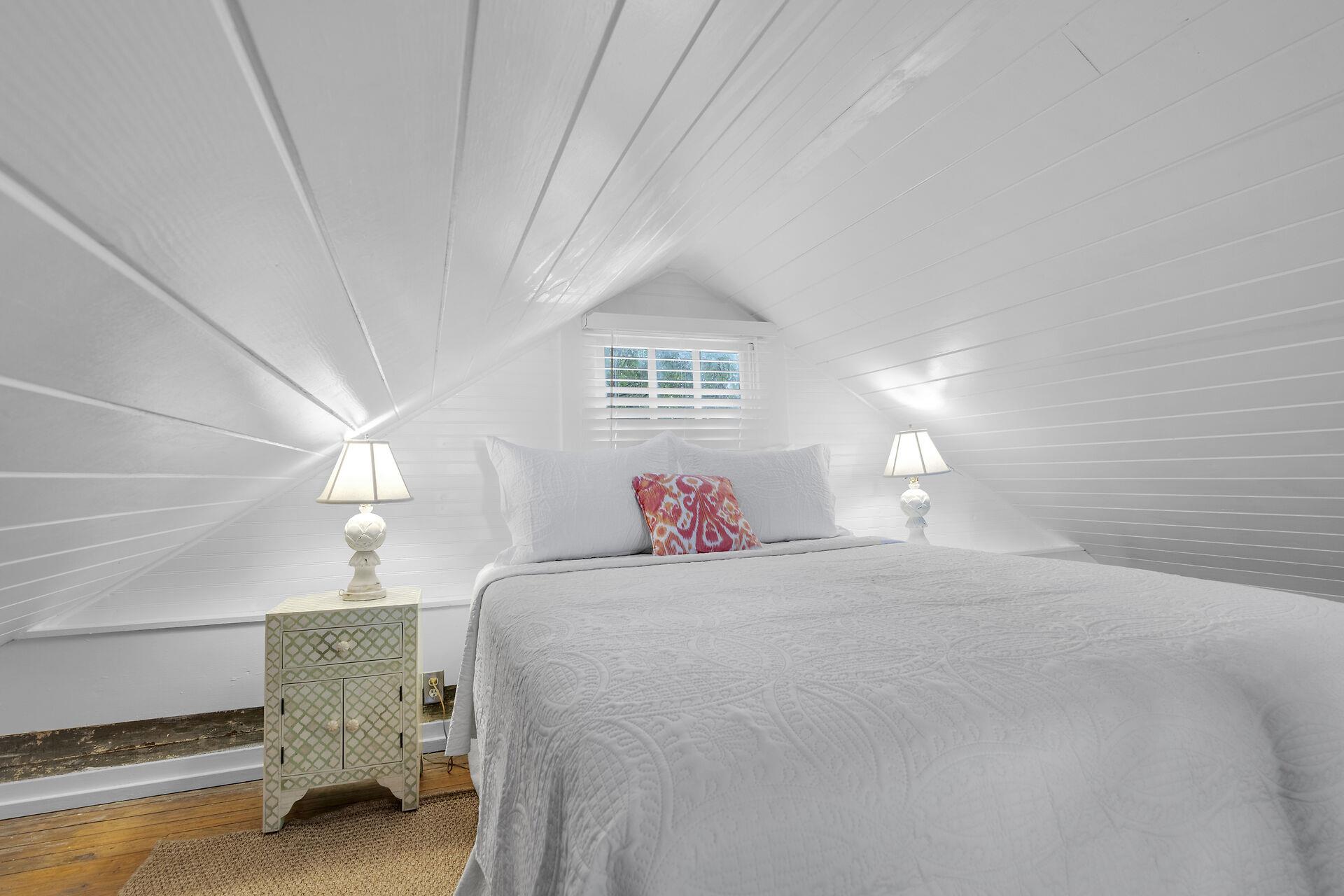 Nightstands and bedside lighting in the open loft