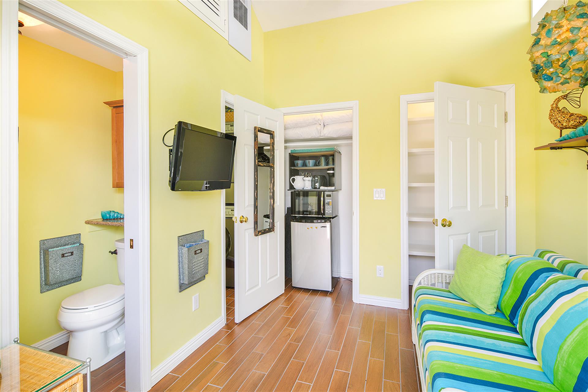 Small pool house includes half bath, TV  kitchenette.