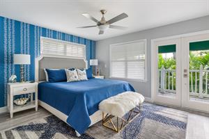 Primary bedroom with king size bed and doors to your private deck.