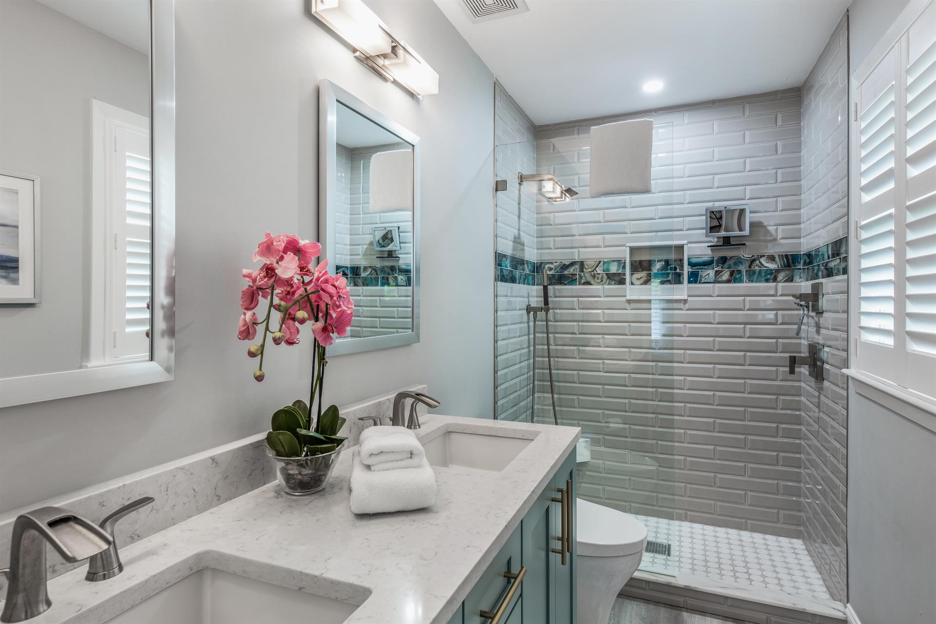 Double sinks and glass walkin shower in this luxurious ensuite bath.