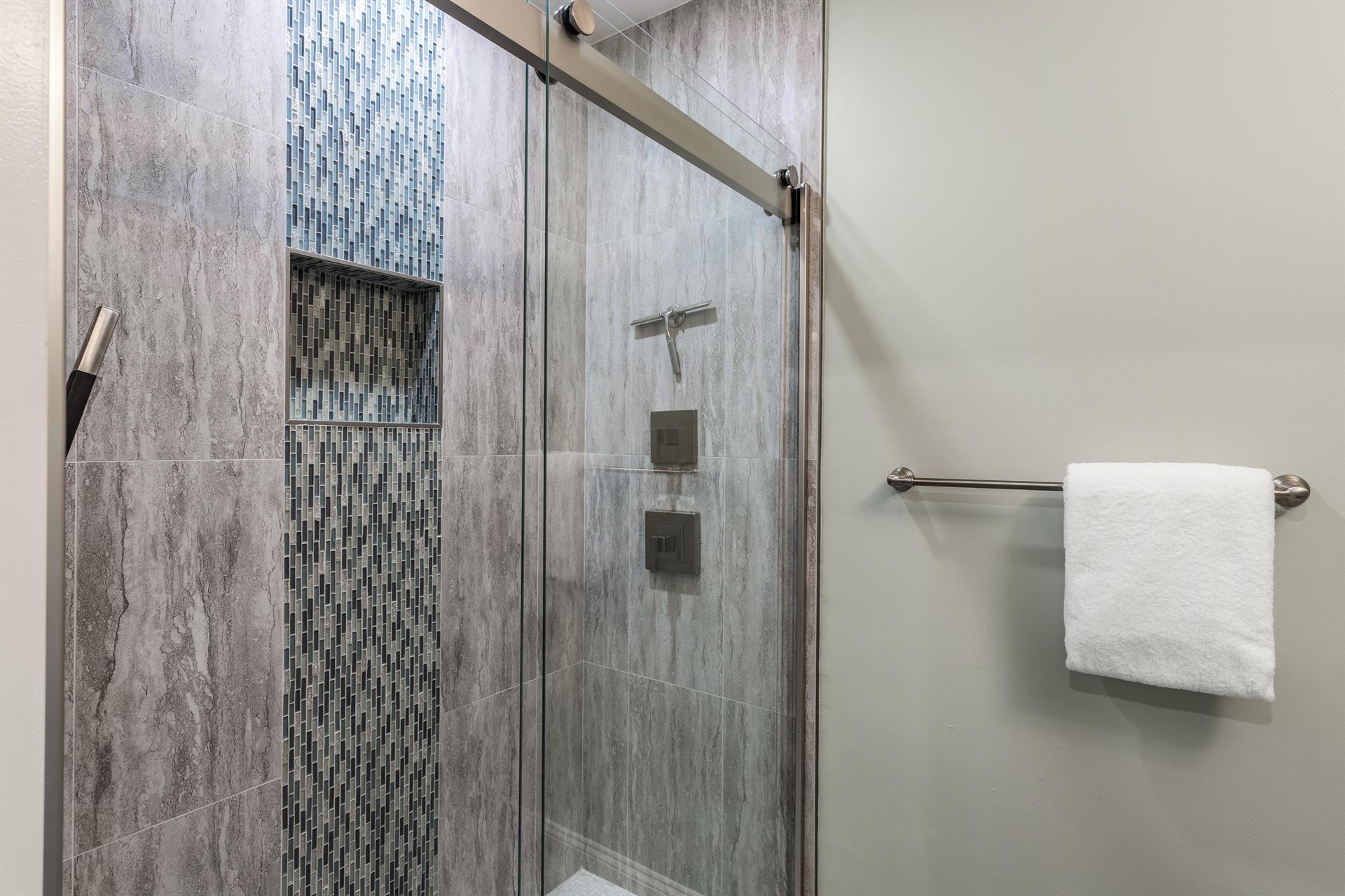 This gorgeous glass walkin shower is perfect for your guests.