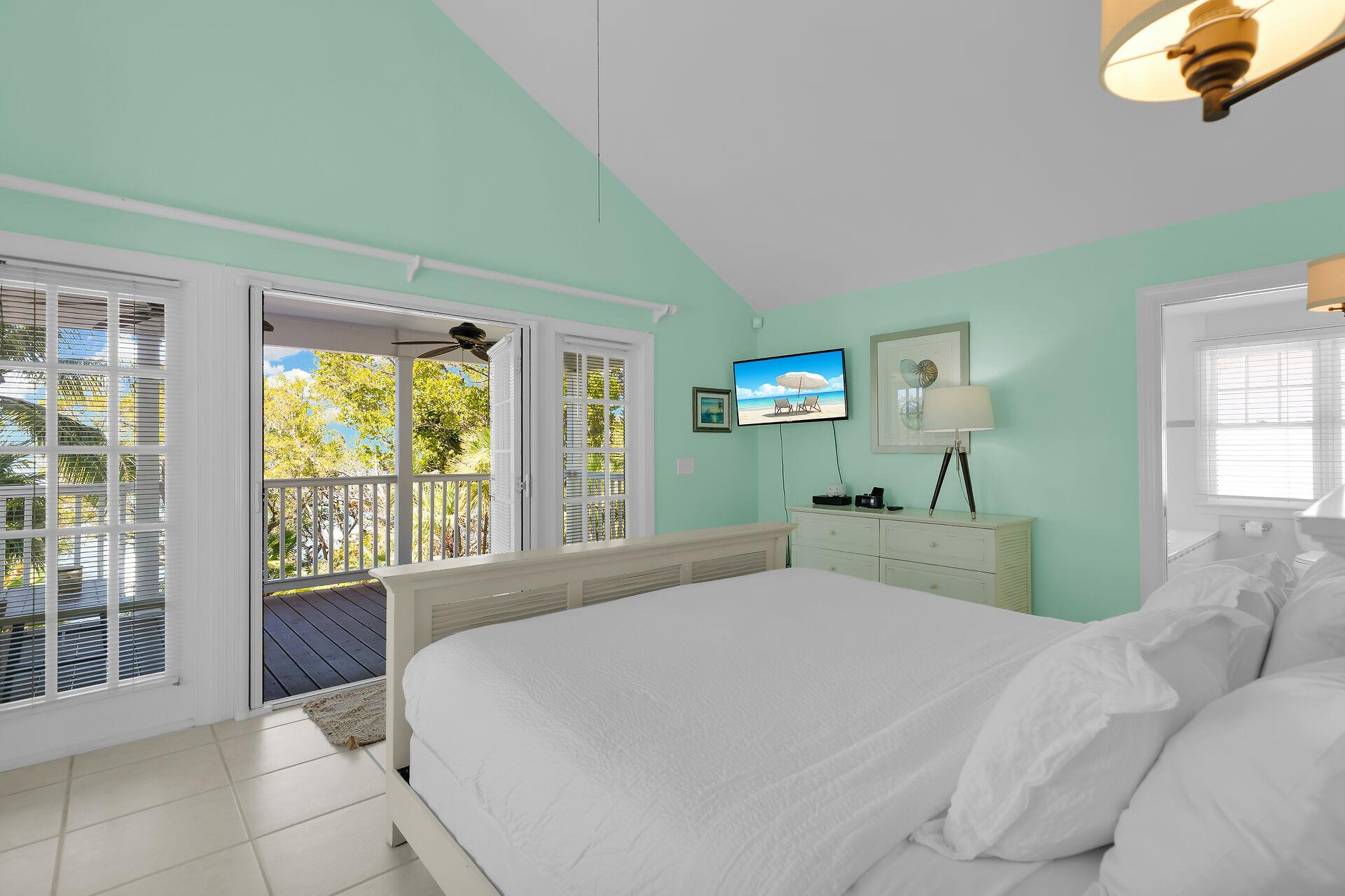 A bright and roomy primary with balcony access.