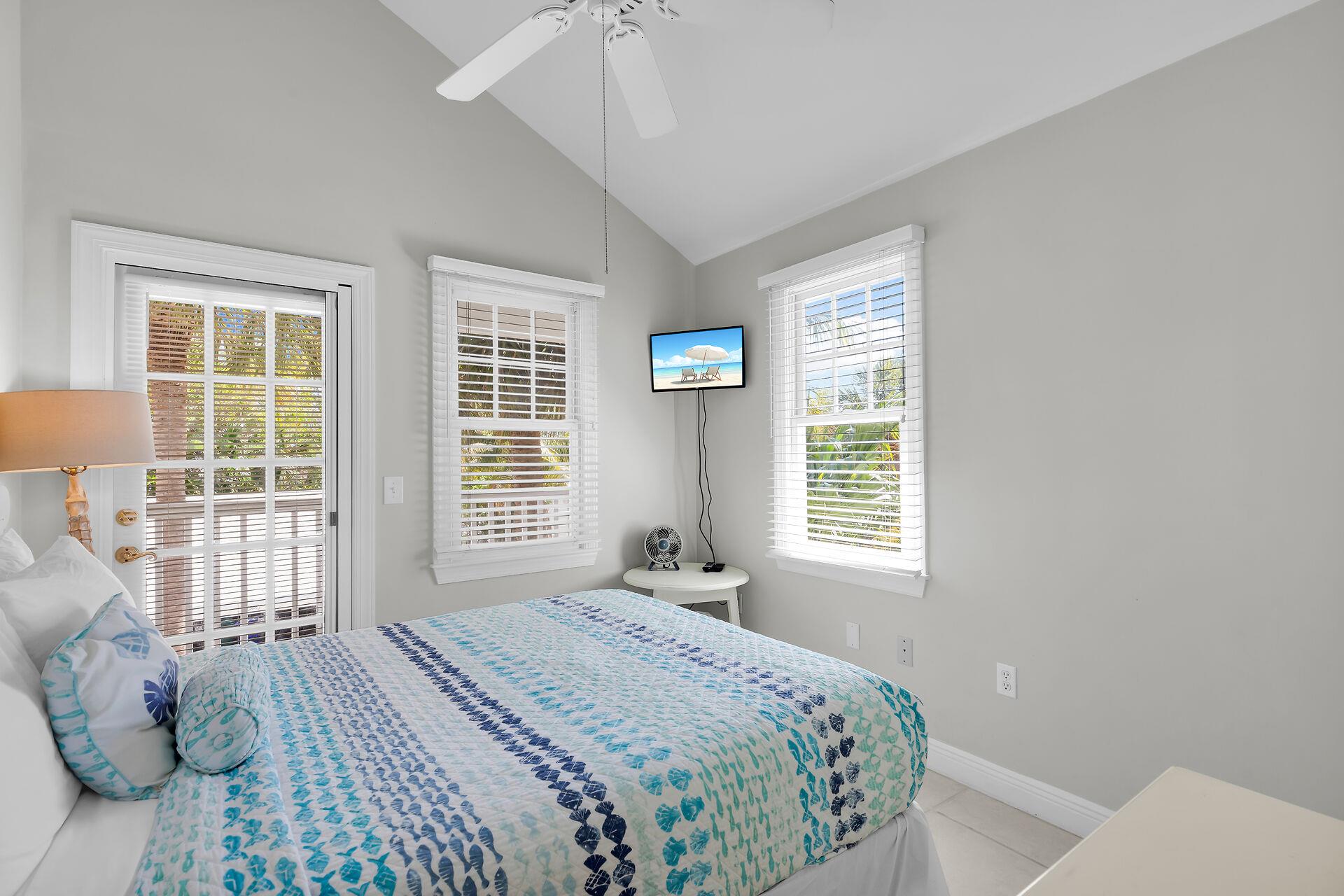 This guest bedroom has natural light and front balcony access.