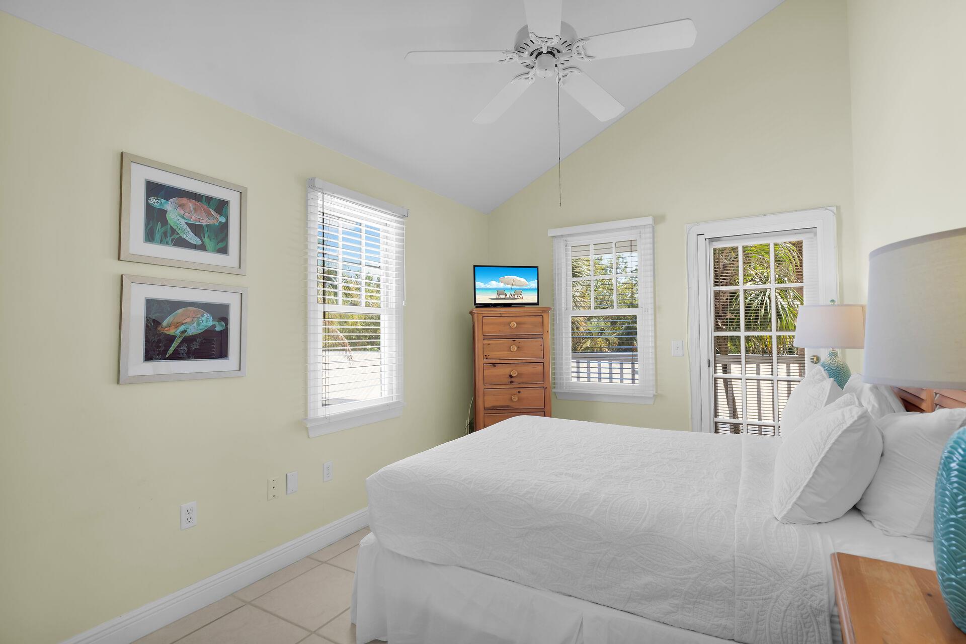 This bedroom features a queen bed and front balcony access.