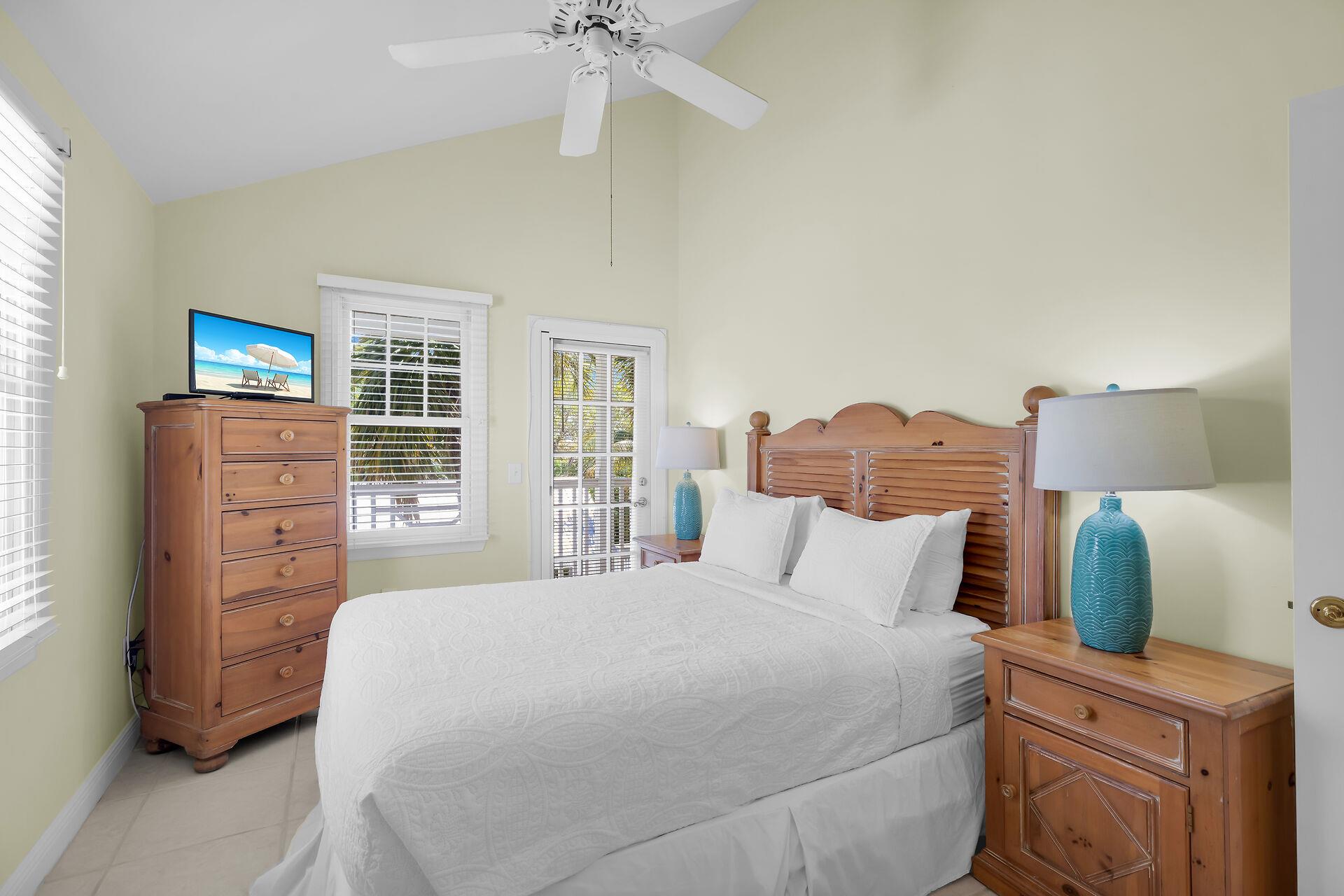 Queen guest room with storage and balcony access.