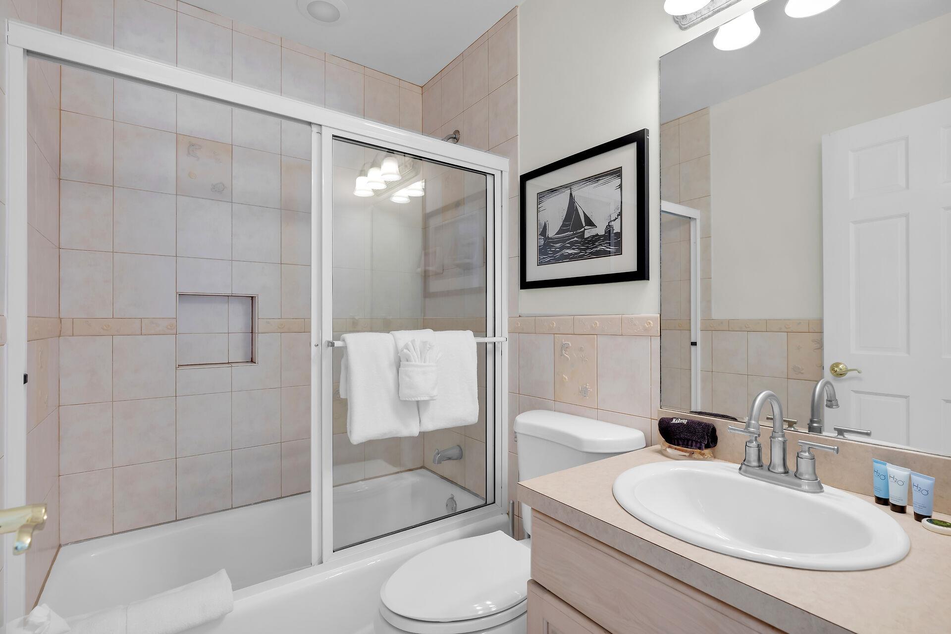 Shared hall bathroom includes a showertub combo.