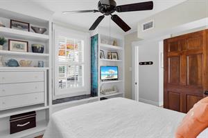 Built in storage and TV complete this cozy bedroom