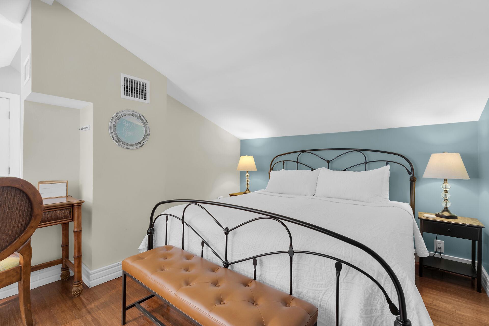 Primary bedroom in open loft offers comfy king sized bed.