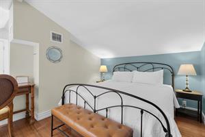 Primary bedroom in open loft offers comfy king sized bed.