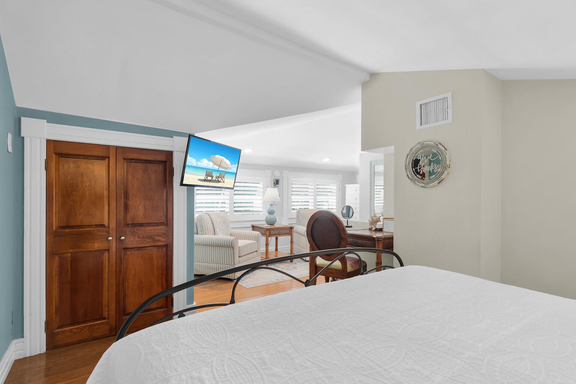 Bright open loft with king bed, desk and seating.