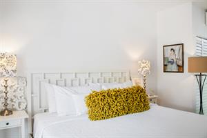 Comfortable king bed with bedside lighting.