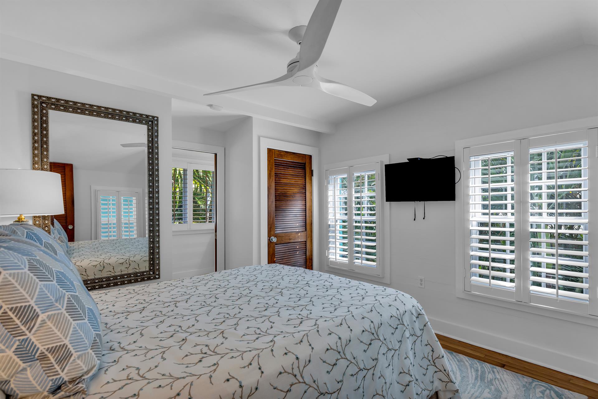 Second floor queen guest bedroom with TV and ceiling fan