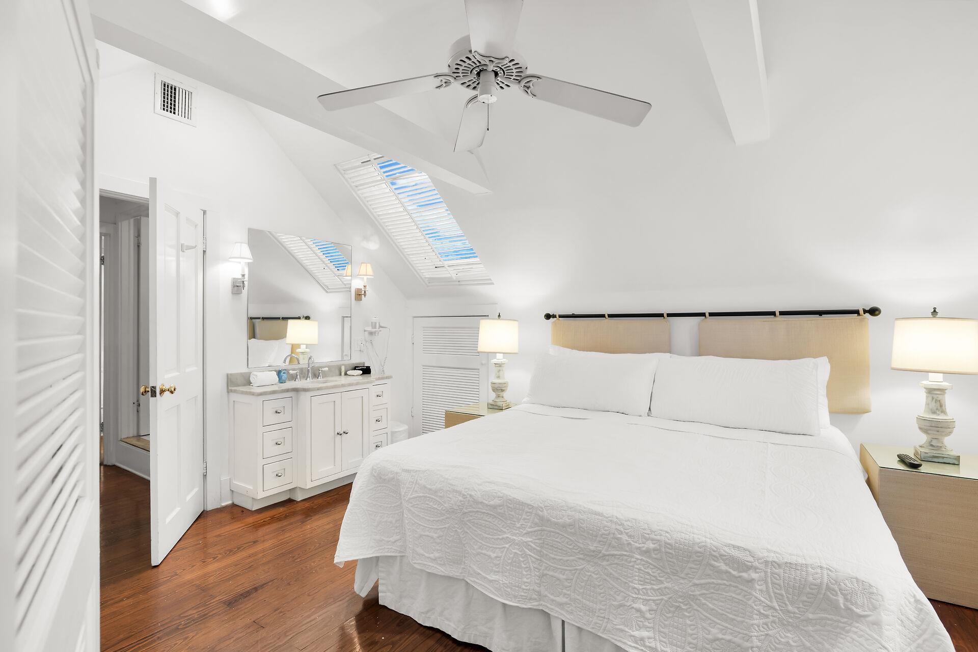 King bedroom with vanity and sink.