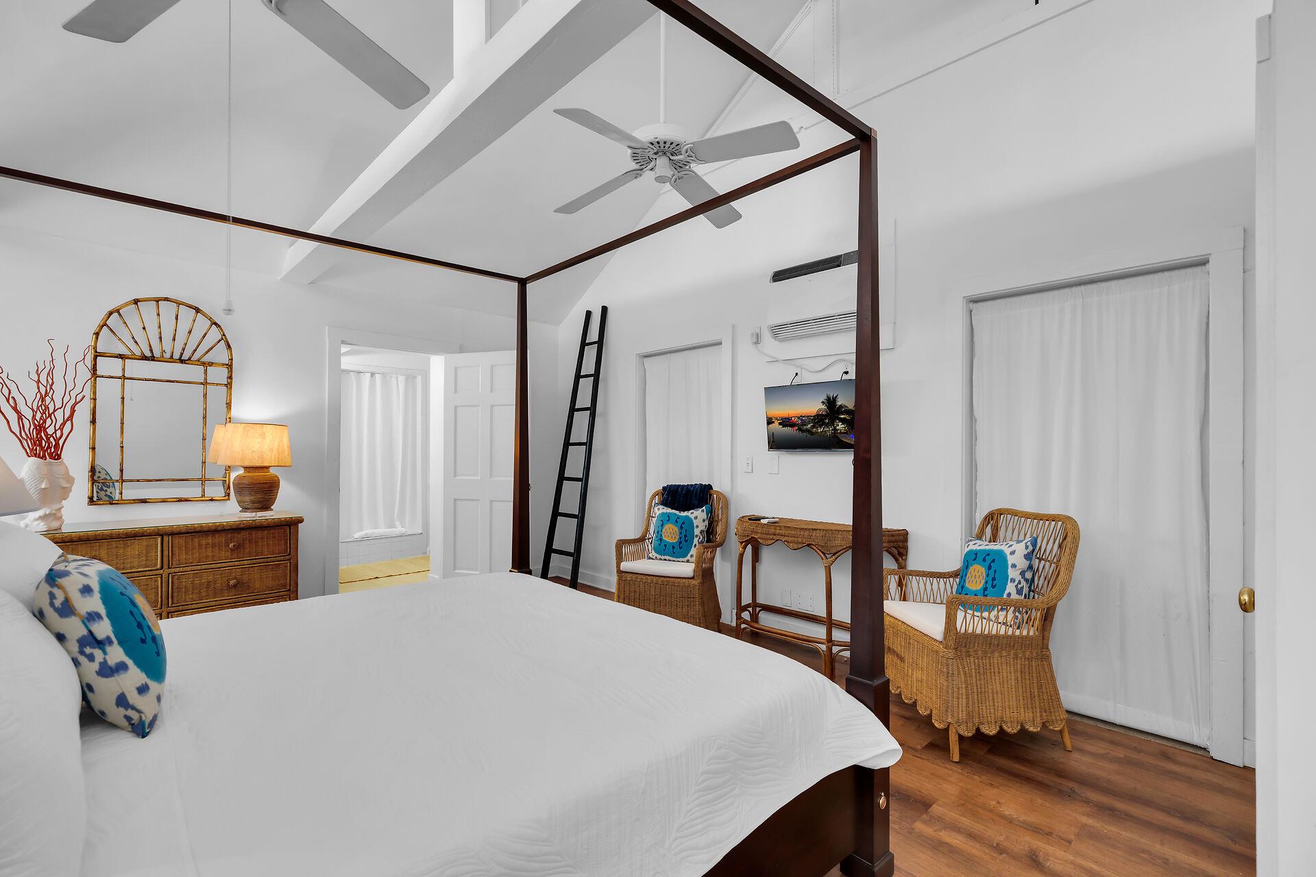 Dresser, seating and a smart TV in the sleeping area.