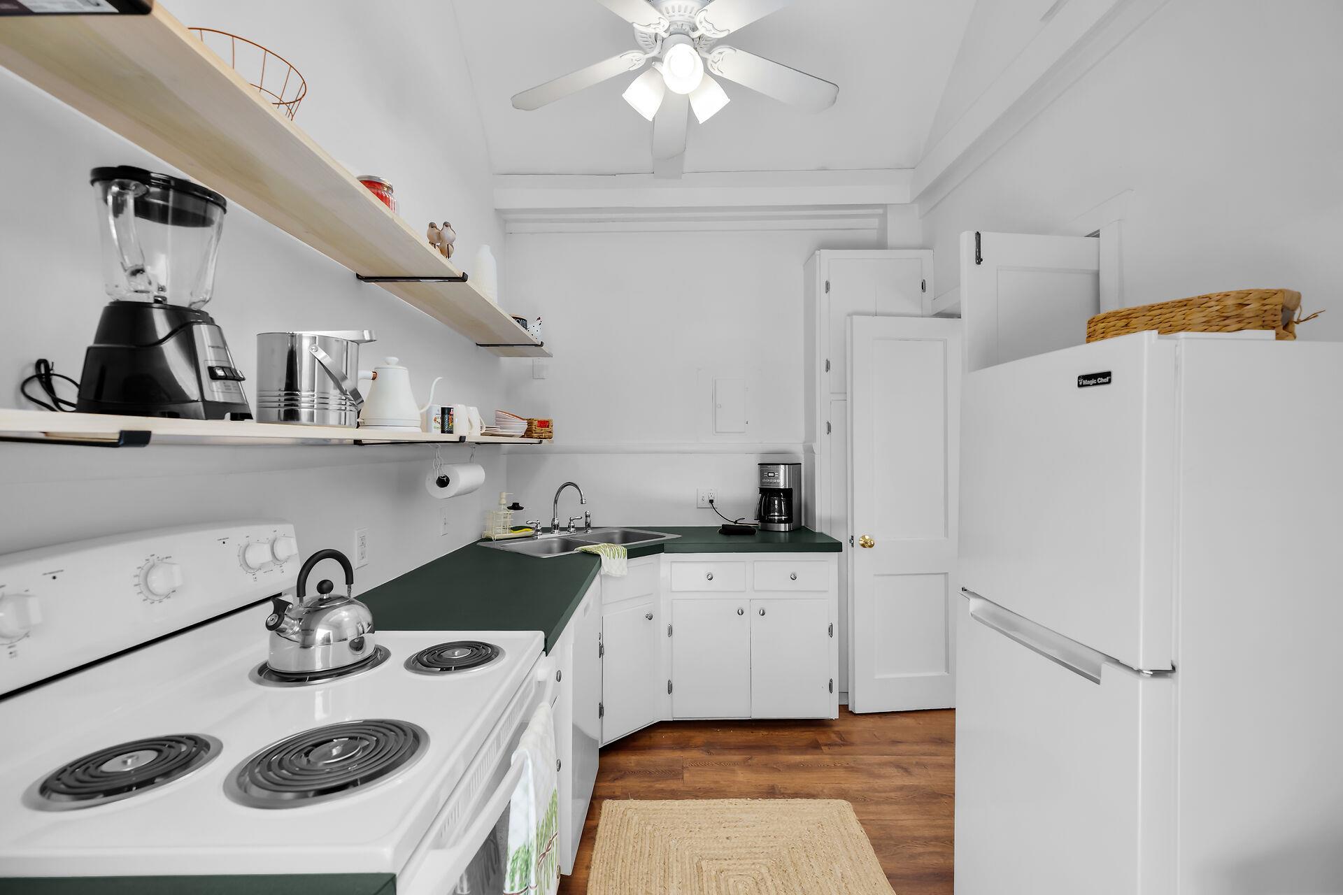 The kitchen has fridge, dishwasher, stove and coffeemaker.