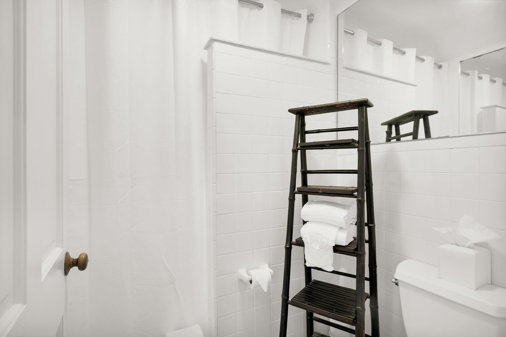 Shared bath has tiled walk in shower.