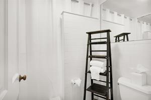 Shared bath has tiled walk in shower.