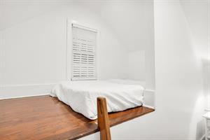 Open loft with full size bed and stair ladder.