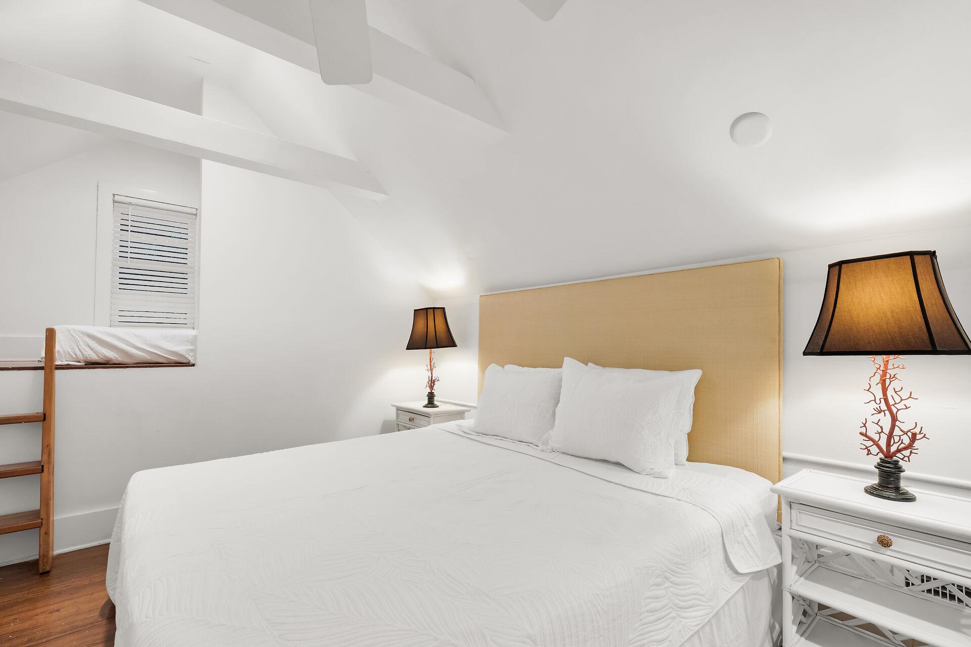 Bedside lighting and ceiling fan in second bedroom.
