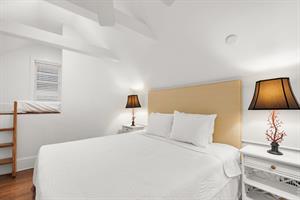 Bedside lighting and ceiling fan in second bedroom.