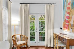 French doors lead to a small patio area.
