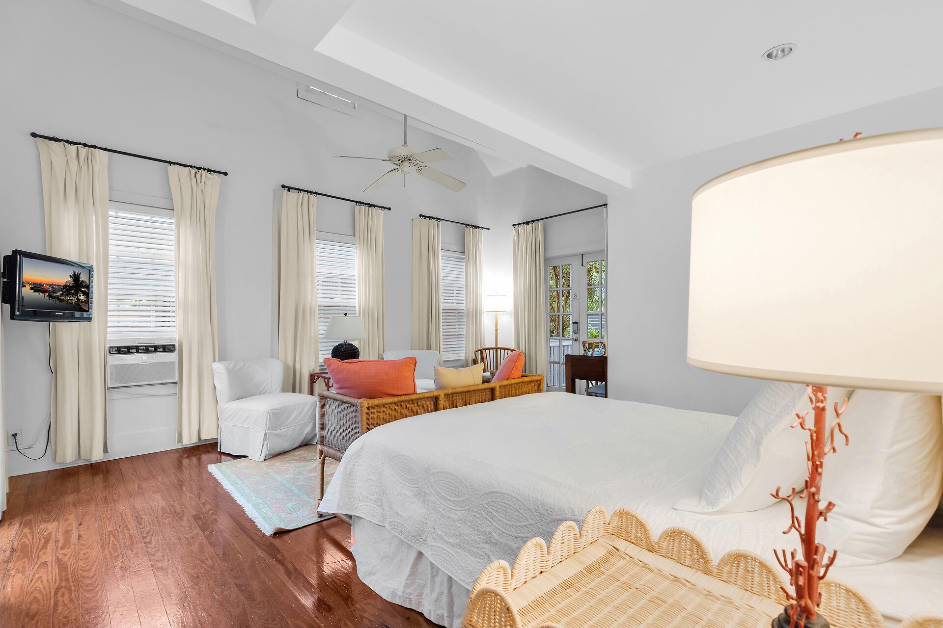Queen bed with bedside lighting and smart TV.